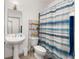 Bathroom features a pedestal sink, mirror, and a shower-tub combo at 12320 Sw 62Nd Pl, Ocala, FL 34481