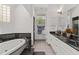 Bathroom featuring a large tub, a separate sink and vanity area, and natural light at 12320 Sw 62Nd Pl, Ocala, FL 34481