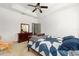 Well-lit bedroom with a large bed, ceiling fan, and a dresser at 12320 Sw 62Nd Pl, Ocala, FL 34481