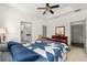 Cozy bedroom with large bed, ceiling fan, ensuite bathroom, and ample natural light at 12320 Sw 62Nd Pl, Ocala, FL 34481
