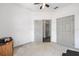 Bedroom features a ceiling fan and leads to a hallway, providing comfort and easy access to other rooms at 12320 Sw 62Nd Pl, Ocala, FL 34481