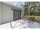 Relaxing screened patio with table and chairs overlooking a treed yard at 12320 Sw 62Nd Pl, Ocala, FL 34481