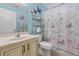 Colorful bathroom with butterfly decor, a modern vanity, and ample storage space at 15549 Sw 11Th Terrace Rd, Ocala, FL 34473