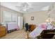 Well-lit bedroom with ceiling fan, laminate floors, plantation shutters, desk, and comfortable bed at 15549 Sw 11Th Terrace Rd, Ocala, FL 34473