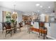 Open-concept dining area with breakfast bar, modern light fixtures, and view to living room and outdoor patio at 15549 Sw 11Th Terrace Rd, Ocala, FL 34473
