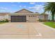 Charming home featuring a decorative driveway, a two-car garage, and well-maintained landscaping at 15549 Sw 11Th Terrace Rd, Ocala, FL 34473