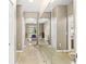 Bright hallway with large mirror leading to a bedroom with ample natural light and beautiful tile flooring at 15549 Sw 11Th Terrace Rd, Ocala, FL 34473