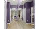 Hallway featuring decorative mirror, tile floor and white doors that lead to other rooms at 15549 Sw 11Th Terrace Rd, Ocala, FL 34473