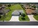 Aerial shot of the property showcasing the home's well-manicured lawn, paver driveway, and serene neighborhood setting at 16215 Sw 15Th Ct, Ocala, FL 34473