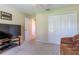 Bedroom with neutral color scheme, plush carpet, TV console, and closet with bi-fold doors at 16215 Sw 15Th Ct, Ocala, FL 34473