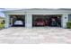 A wide view shows this home's 3-car garage with its patterned concrete driveway and excellent curb appeal at 16215 Sw 15Th Ct, Ocala, FL 34473