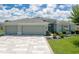 Charming single-story home with a three-car garage, well-maintained lawn, and landscaped garden beds at 16215 Sw 15Th Ct, Ocala, FL 34473