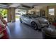 Garage featuring a light blue convertible car, epoxy floor, and ample space for storage at 16215 Sw 15Th Ct, Ocala, FL 34473