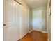 Hallway featuring wood-look flooring, a closet with sliding doors, and a white door leading to another room at 16215 Sw 15Th Ct, Ocala, FL 34473