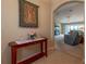 Hallway featuring decor, archway into living room with plush carpet, and neutral paint scheme at 16215 Sw 15Th Ct, Ocala, FL 34473