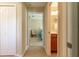 Inviting hallway featuring access to a bedroom, bathroom, and closet, all with neutral walls and tile flooring at 16215 Sw 15Th Ct, Ocala, FL 34473
