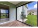 Covered patio featuring tile flooring, sliding glass doors, and a stainless steel grill, perfect for outdoor entertaining at 16215 Sw 15Th Ct, Ocala, FL 34473