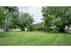 Large, meticulously maintained backyard with lush green grass, mature trees, and privacy fencing at 17034 Florence View Dr, Montverde, FL 34756