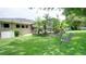 Spacious backyard features lush green lawn, mature trees, and screened pool area; a private oasis at 17034 Florence View Dr, Montverde, FL 34756