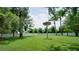 Expansive backyard with lush lawn, mature trees, and white picket fence, great for outdoor activities at 17034 Florence View Dr, Montverde, FL 34756