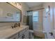 Well-lit bathroom features a white vanity with black fixtures and a shower/tub combo at 17034 Florence View Dr, Montverde, FL 34756