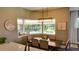Well-lit dining room features a modern light fixture, seating for six, and views of the pool at 17034 Florence View Dr, Montverde, FL 34756