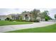 Lovely one-story home with lush green lawn, mature landscaping and a large, paved driveway leading to the garage at 17034 Florence View Dr, Montverde, FL 34756