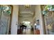 Grand foyer featuring high ceilings, hardwood floors, decorative moldings, and an elegant piano at 17034 Florence View Dr, Montverde, FL 34756