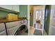 Well-lit laundry room featuring modern Samsung washer and dryer, with views of the bedroom at 17034 Florence View Dr, Montverde, FL 34756