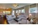 Bright living room featuring sofas, large windows with natural light and an open floorplan at 17034 Florence View Dr, Montverde, FL 34756