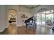 Bright living room with hardwood floors, piano, and sliding glass doors leading to the outdoor space at 17034 Florence View Dr, Montverde, FL 34756