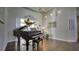 Stunning living room showcasing hardwood floors, neutral decor, and a stylish Yamaha piano at 17034 Florence View Dr, Montverde, FL 34756