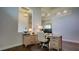 Comfortable office space with a built-in desk, wood floors, and neutral walls at 17034 Florence View Dr, Montverde, FL 34756