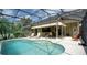 Screened-in pool with sun loungers and outside dining, perfect for relaxation and entertaining at 17034 Florence View Dr, Montverde, FL 34756