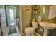 Convenient powder room featuring a modern pedestal sink, mirror, and storage shelves at 17034 Florence View Dr, Montverde, FL 34756