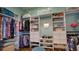 Custom walk-in closet with built-in shelving, drawers, and ample storage space at 17034 Florence View Dr, Montverde, FL 34756