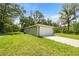Spacious backyard showing the home's exterior and attached garage on a sunny day at 1708 Nw 27Th Ave, Ocala, FL 34475