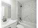 Renovated bathroom featuring shower-tub combination with marble-look tiling at 1708 Nw 27Th Ave, Ocala, FL 34475