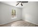 Bright bedroom with wood-look flooring and a window showcasing nature at 1708 Nw 27Th Ave, Ocala, FL 34475