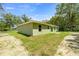 Exterior view of the home showcasing the yard and landscaping at 1708 Nw 27Th Ave, Ocala, FL 34475