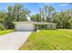 Charming single-story home features a well-manicured lawn and an attached two-car garage at 1708 Nw 27Th Ave, Ocala, FL 34475
