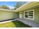 Close-up of a white front door with a window and a walkway leading to a well-maintained lawn at 1708 Nw 27Th Ave, Ocala, FL 34475