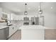 Bright kitchen features white cabinets, stainless steel appliances, and a central island with pendant lighting at 1708 Nw 27Th Ave, Ocala, FL 34475
