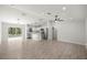 Open-concept living area with modern wood-look tile flooring and stainless steel appliances at 1708 Nw 27Th Ave, Ocala, FL 34475