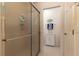 Bathroom view featuring tile flooring, white cabinets, and shower with glass doors at 1768 Sw 156Th Ln, Ocala, FL 34473