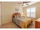 Bedroom featuring a bed, ceiling fan, shutters, and light yellow paint at 1768 Sw 156Th Ln, Ocala, FL 34473