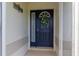 Welcoming front door with wreath and decorative sign, offering a warm entrance to the home at 1768 Sw 156Th Ln, Ocala, FL 34473