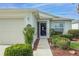 Inviting front entrance featuring a decorative storm door, manicured bushes, and a clear address marker at 1768 Sw 156Th Ln, Ocala, FL 34473