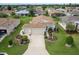 Well-manicured home with a spacious driveway, lush landscaping, and a two-car garage at 1768 Sw 156Th Ln, Ocala, FL 34473