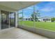 Screened lanai offering views of the lush green lawn and neighboring homes at 1768 Sw 156Th Ln, Ocala, FL 34473